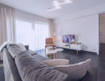 a view of a living room with a bed and looking at the camera